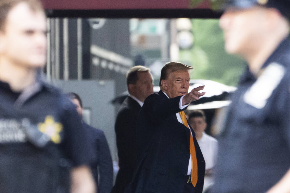 Former president Donald Trump waves while leaving Trump Tower on his way to Manhattan criminal ...