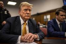 Former President Donald Trump sits in a courtroom next to his lawyer Todd Blanche, right, befor ...