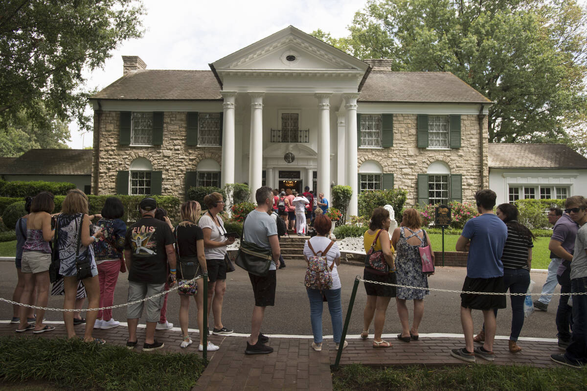 Fans wait in line outside Graceland on Tuesday, Aug. 15, 2017, in Memphis, Tenn. (AP Photo/Bran ...