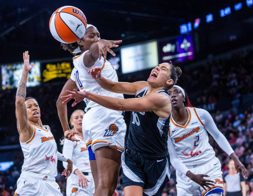 Aces guard Kelsey Plum (10) takes a hard foul from Phoenix Mercury forward Liz Dixon (20) as sh ...