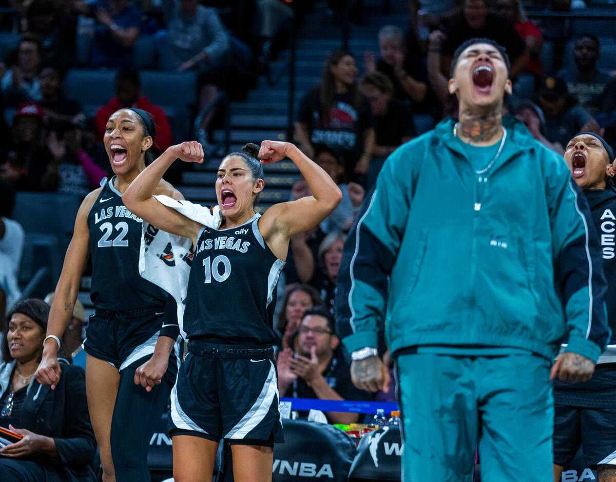 Aces center A'ja Wilson (22) and Aces guard Kelsey Plum (10) celebrate a big play by a teammate ...