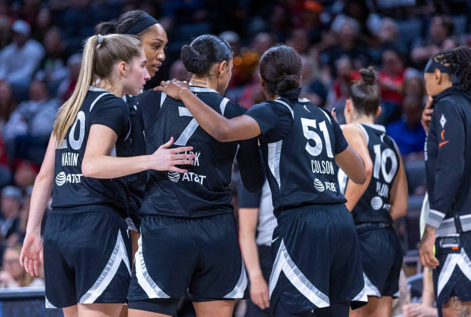 Aces players come together on a timeout against the Phoenix Mercury during the first half of th ...