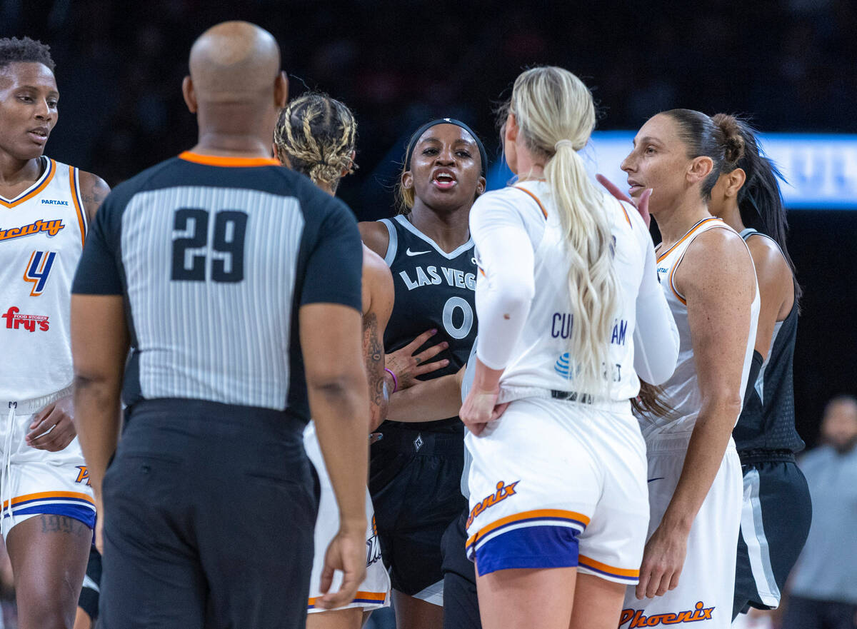 Aces guard Jackie Young (0) yells at Phoenix Mercury guard Sophie Cunningham (9) as the two tan ...