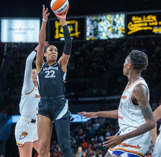 Aces center A'ja Wilson (22) gets off a short for points as Phoenix Mercury forward Natasha Mac ...