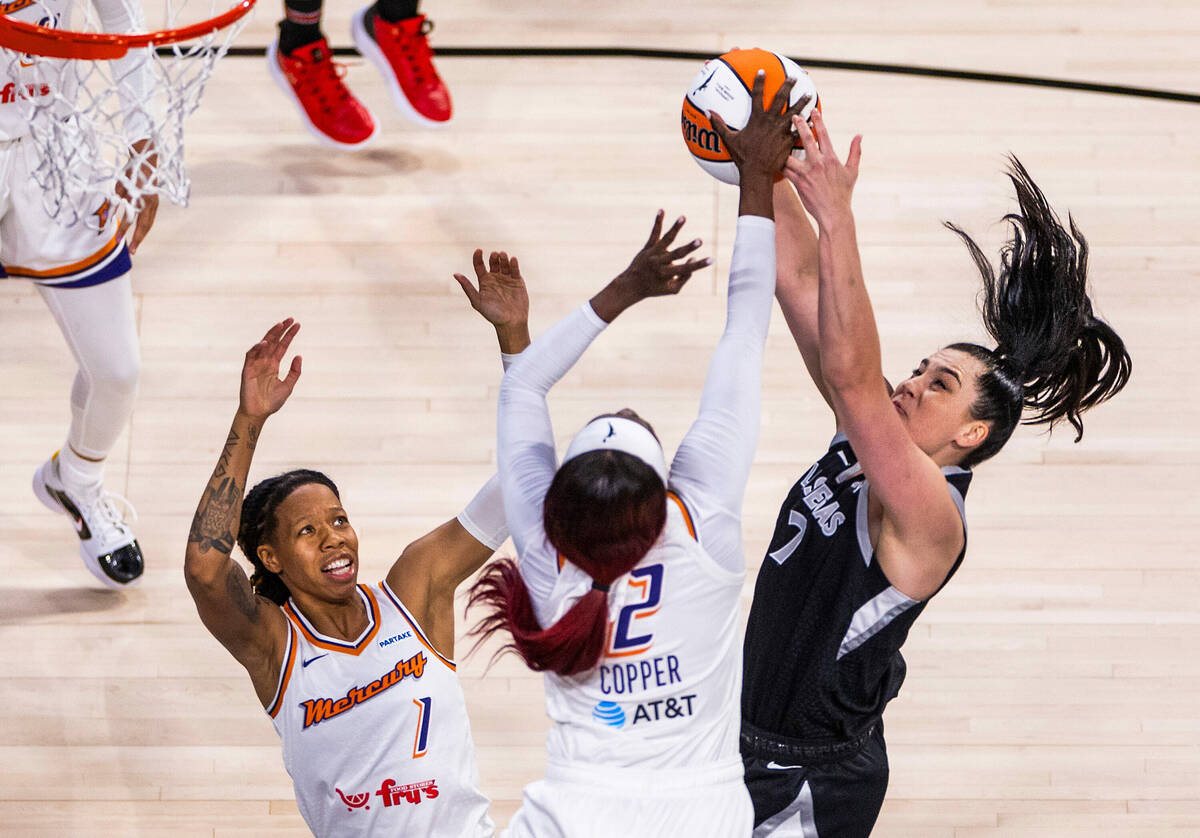 Aces center Megan Gustafson (17) and Phoenix Mercury guard Kahleah Copper (2) battle for a rebo ...