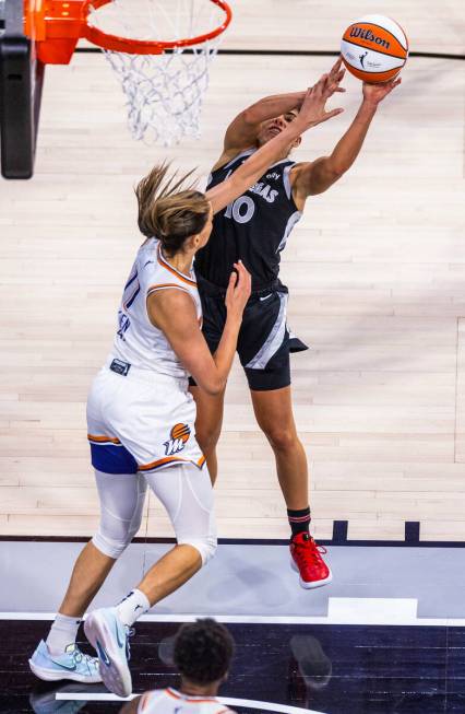 Aces guard Kelsey Plum (10) is fouled on a shot by Phoenix Mercury guard Rebecca Allen (11) dur ...