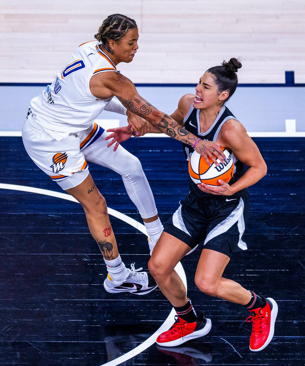 Aces guard Kelsey Plum (10) has her arm grabbed but no foul call against Phoenix Mercury guard ...