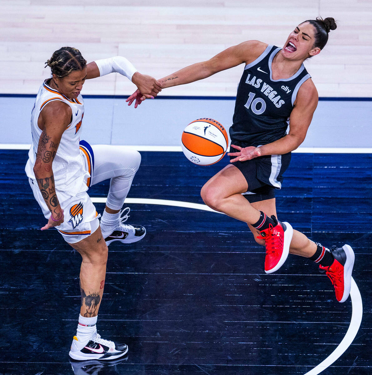 Aces guard Kelsey Plum (10) has her arm grabbed but no foul call against Phoenix Mercury guard ...