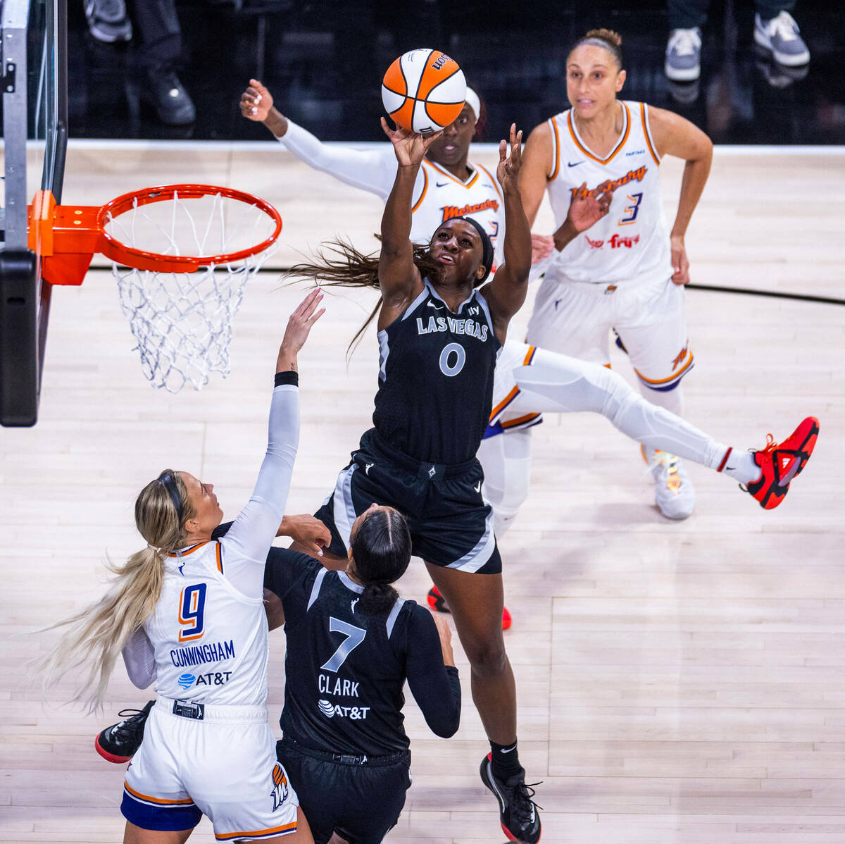 Aces guard Jackie Young (0) posts up for a late basket over Phoenix Mercury guard Sophie Cunnin ...