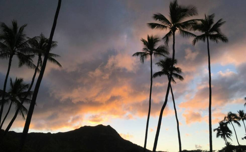The sun rises behind the Diamond Head State Monument in Honolulu in 2018. (AP Photo/Eric Risberg)
