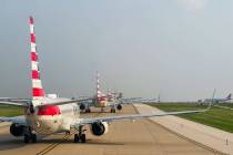 American Airlines planes wait in a long line for takeoff at DFW Airport on Tuesday, May 21, 202 ...