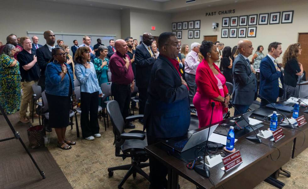 Attendees stand for the Pledge of Allegiance as the NSHE Board of Regents meeting begins where ...