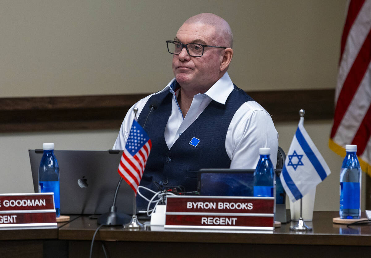 Regent Byron Brooks has both American and Israeli flags about his nameplate during NSHE Board o ...
