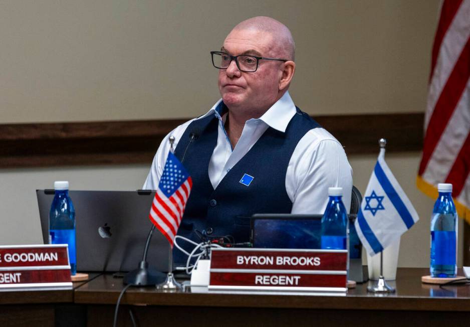 Regent Byron Brooks has both American and Israeli flags about his nameplate during NSHE Board o ...