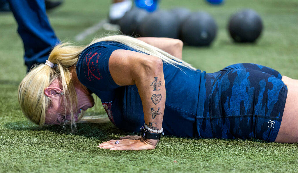 A participant does push ups during the Las Vegas Fire & Rescue free community boot camp at ...
