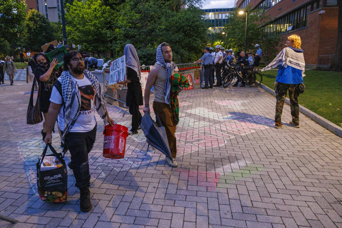 Protesters leave a pro-Palestinian encampment at Drexel University early Thursday, May 23, 2024 ...