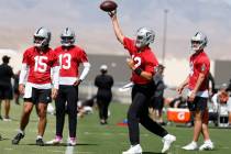 Raiders quarterback Aiden O'Connell (12) throws the ball as backup quarterbacks Gardner Minshew ...