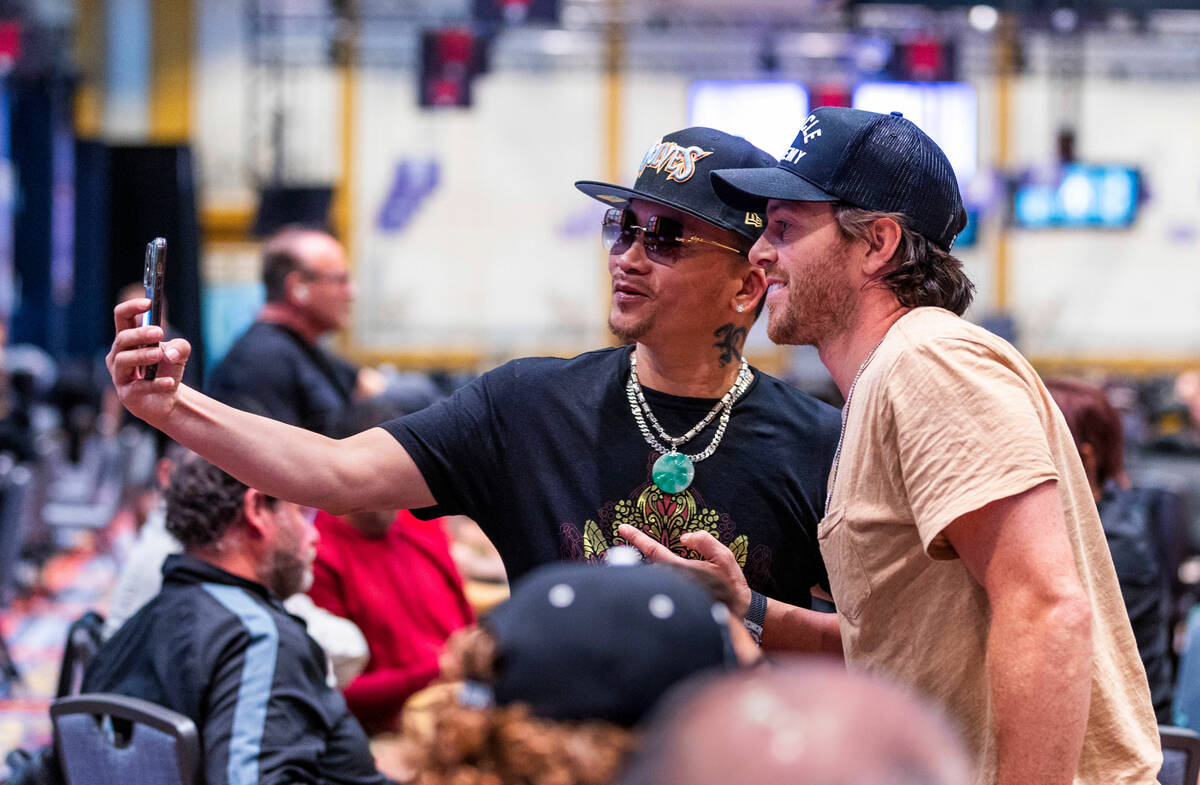 Qui Nguyen takes a photo with the Golden Knights Jonathan Marchessault during the WSOP opening ...