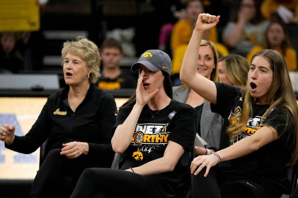 Iowa coach Lisa Bluder, left, guard Caitlin Clark and guard Kate Martin, right, react to fans d ...