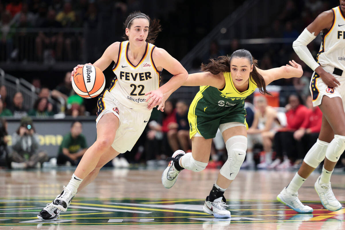 Indiana Fever guard Caitlin Clark (22) drives as Seattle Storm guard Nika Muhl defends during t ...