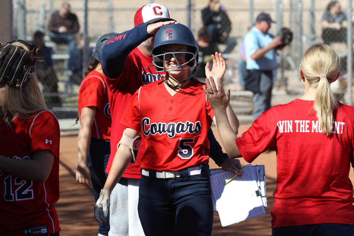 Coronado's Tatum Spangler is congratulated by teammates and coaches after hitting a home run of ...
