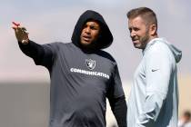 Raiders head coach Antonio Pierce, left, discusses with Scott Turner, team's pass game coordina ...