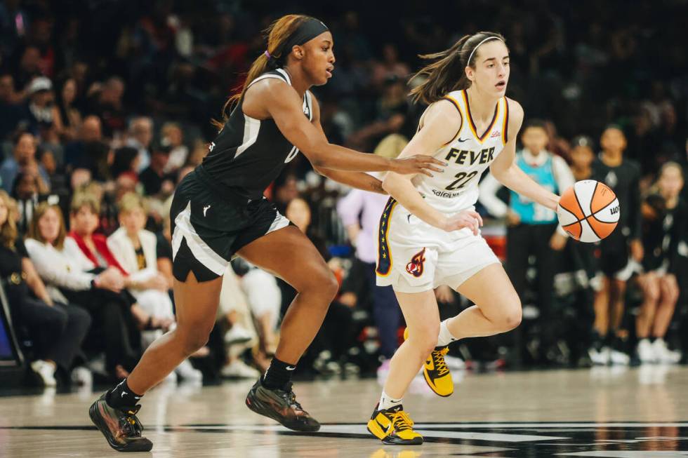 Aces guard Jackie Young (0) guards Indiana Fever guard Caitlin Clark (22) during a game between ...