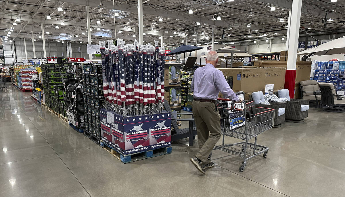 A shopper moves past a display of items in a Costco warehouse Saturday, May 18, 2024, in Sherid ...