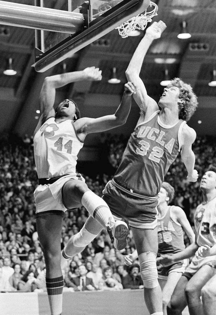 FILE - UCLA's Bill Walton (32) fights Notre Dame's Adrian Dantley (44) for a rebound during an ...
