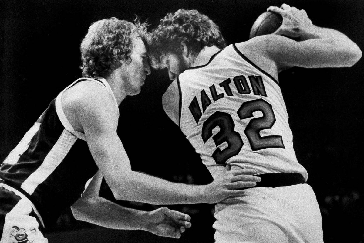 Denver Nuggets' Dan Issel, left, guards Portland Trail Blazers' Bill Walton as Walton moves tow ...