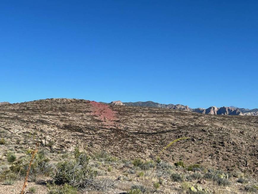 Fire retardant is seen Tuesday morning as firefighters work to contain the Bird Springs Fire, l ...