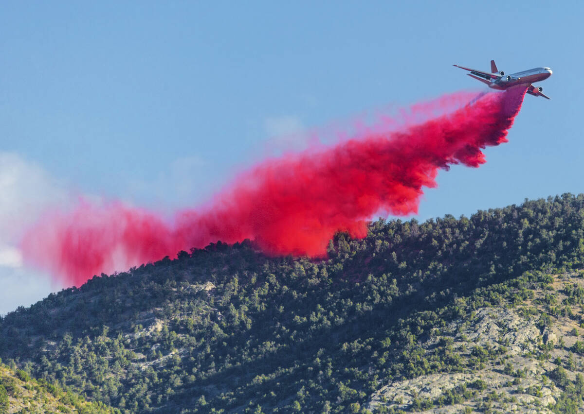 An air tanker drops fire retardant while fighting the Mahogany Fire on Mount Charleston on June ...