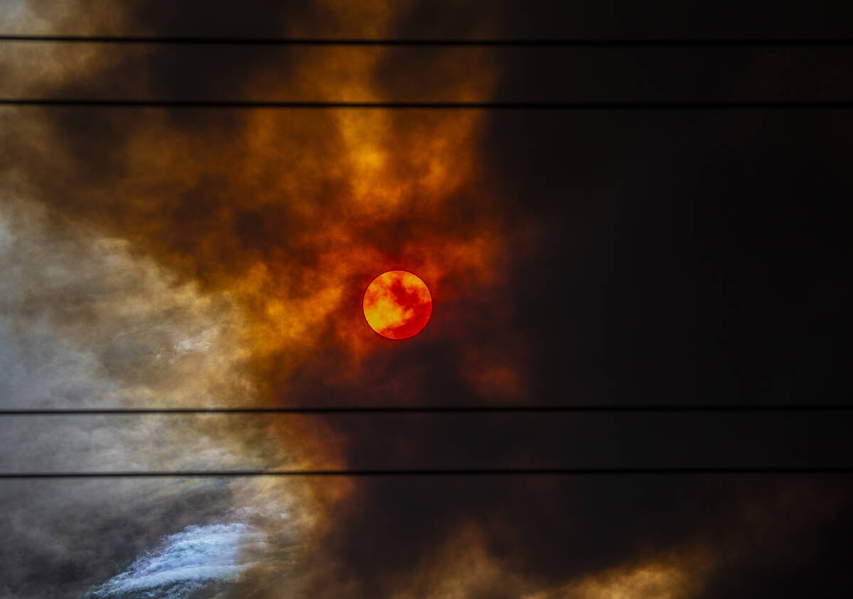 The sun is blanketed in red smoke originating from the Mahogany Fire near Mount Charleston on J ...
