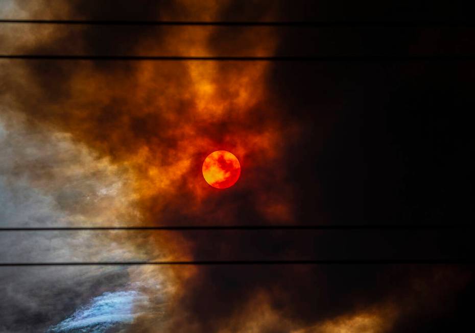The sun is blanketed in red smoke originating from the Mahogany Fire near Mount Charleston on J ...