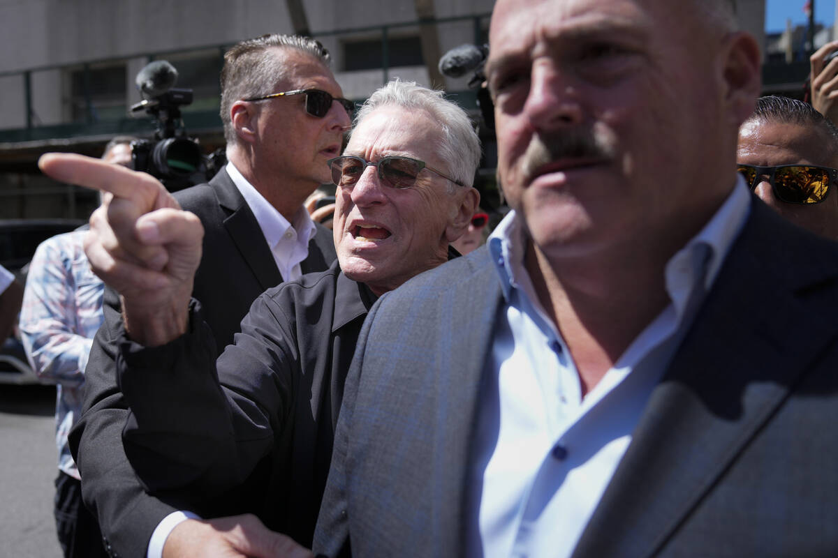Robert De Niro, center, argues with a Donald Trump supporter after speaking to reporters in sup ...