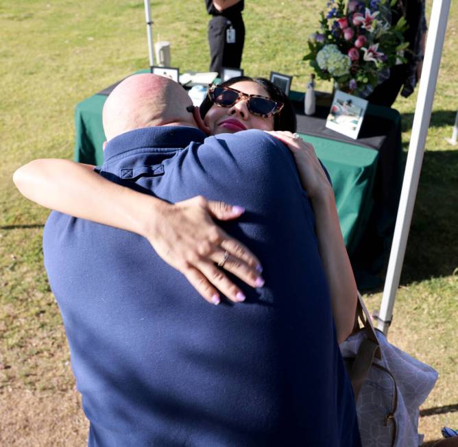 Brooke Prendes, daughter of fallen Las Vegas police Sgt. Henry Prendes, gets a hug from family ...