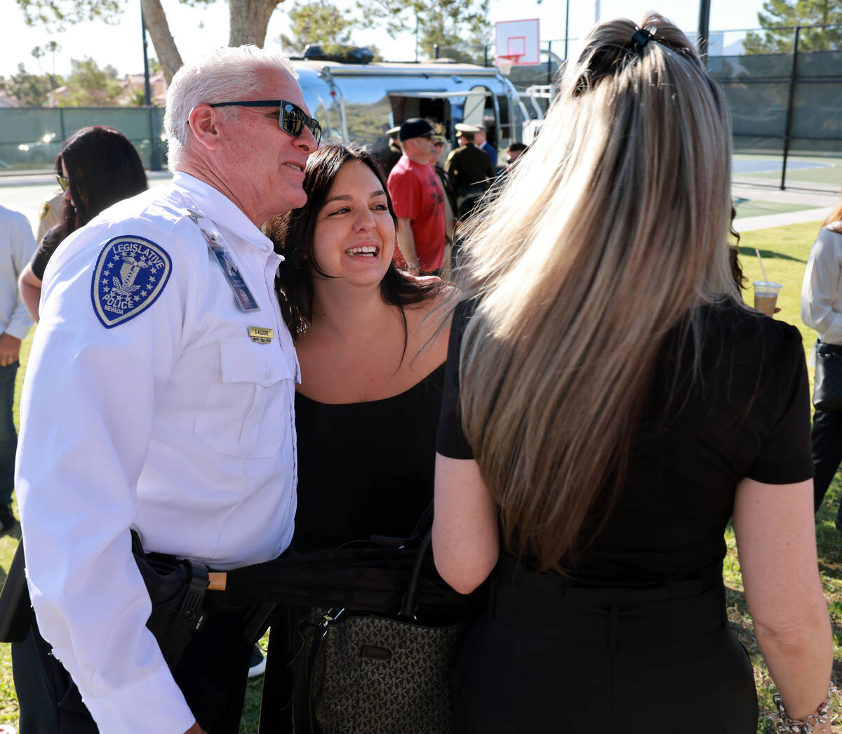 Kylee Prendes, daughter of fallen Las Vegas police Sgt. Henry Prendes, right, gets a hug from L ...