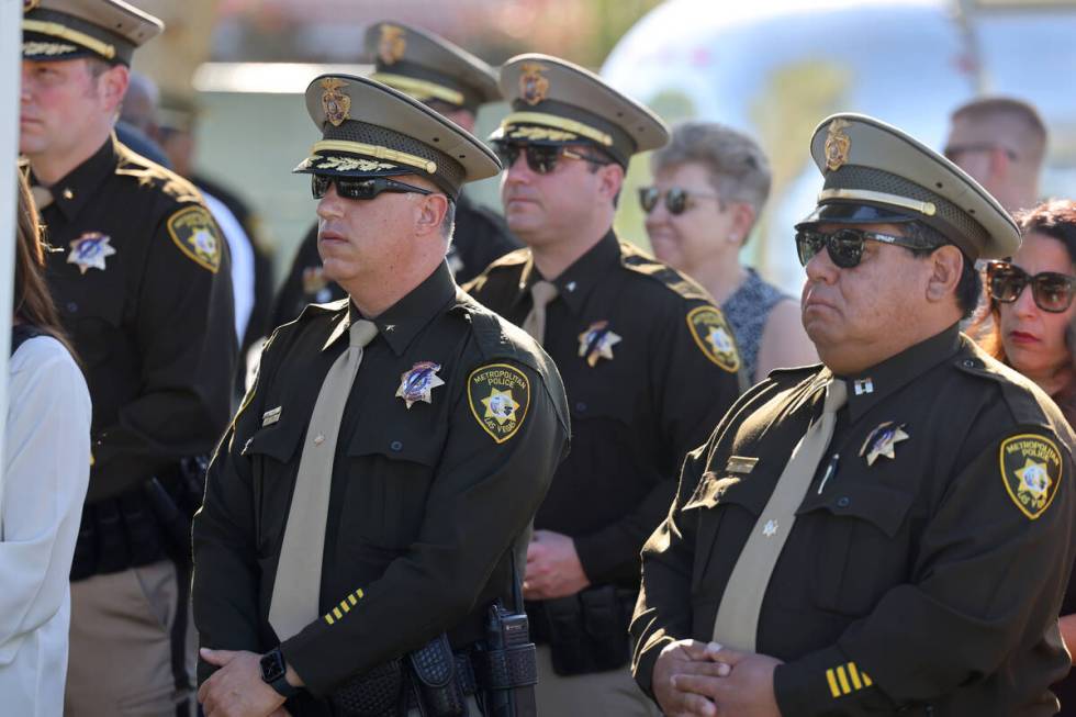 Las Vegas police officers listen during a ceremony to rename a Las Vegas park in the officer&#x ...