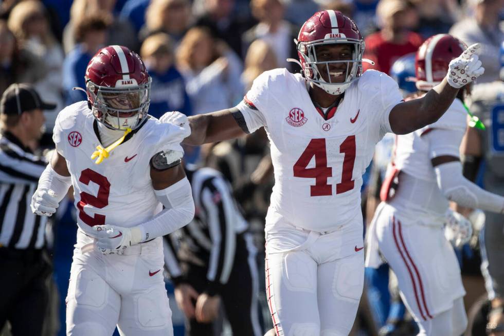 Alabama defensive back Caleb Downs (2) and linebacker Chris Braswell (41) celebrate a fumble re ...