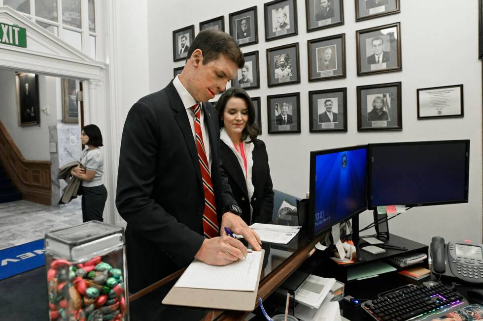 Republican U.S. Senatorial candidate Sam Brown, with wife Amy Brown, signs in at the secretary ...