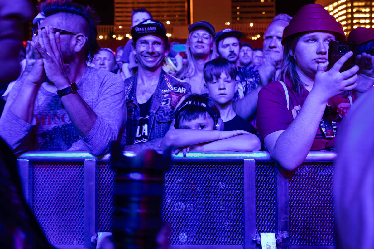 A young attendee looks out from the barricade as Devo performs during the Punk Rock Bowling mus ...