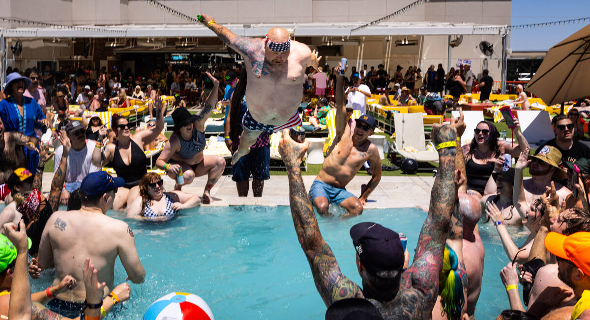 A festival attendees jumps into the pool during the daytime Punk Rock Bowling festival pool par ...