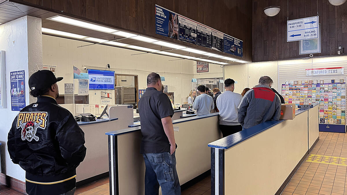 People line up at the United States Post Office’s Barbara F. Vucanovich Facility on Vass ...