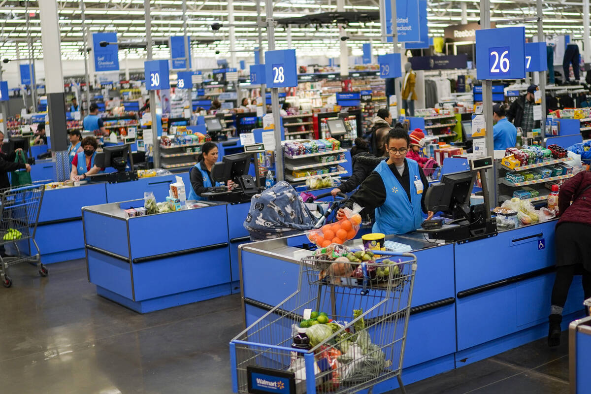 Cashiers process purchases at a Walmart Supercenter in North Bergen, N.J., on Feb. 9, 2023. (AP ...