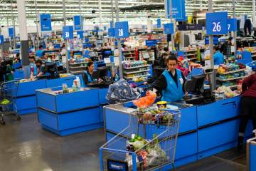 Cashiers process purchases at a Walmart Supercenter in North Bergen, N.J., on Feb. 9, 2023. (AP ...
