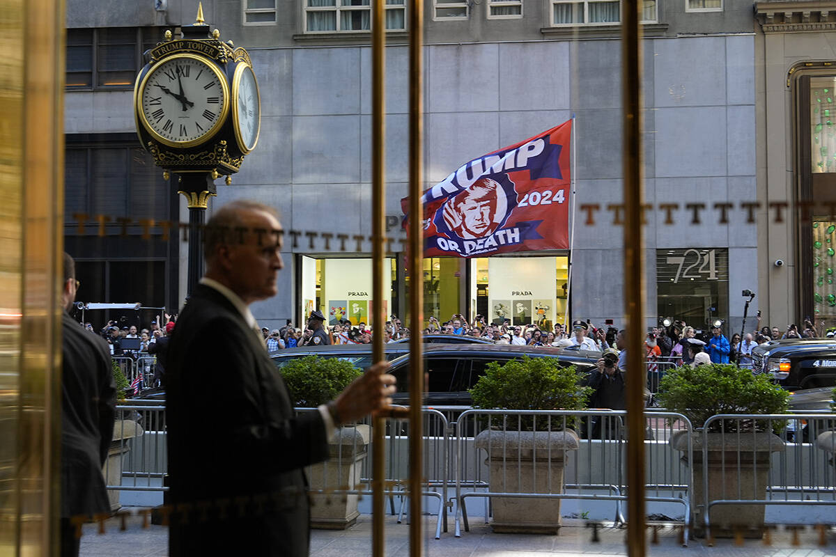 A crowd gathers across the street from Trump Tower, Friday, May 31, 2024, in New York. A day af ...