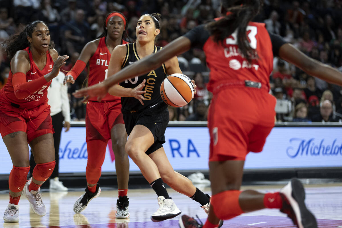 Las Vegas Aces guard Kelsey Plum (10) runs for a layup while Atlanta Dream forward Cheyenne Par ...