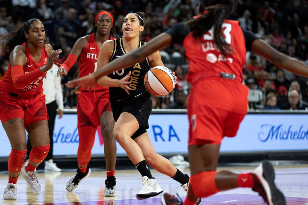 Las Vegas Aces guard Kelsey Plum (10) runs for a layup while Atlanta Dream forward Cheyenne Par ...