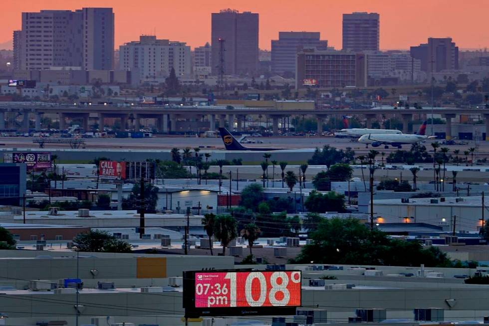 The unofficial temperature hits 108 degrees at dusk at Sky Harbor International Airport in Phoe ...