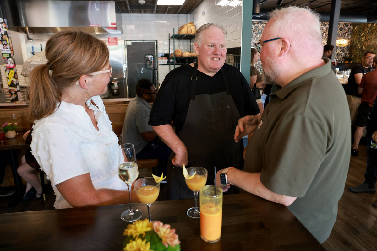 Esther’s Kitchen chef-owner James Trees, center, mingles with Brenda and Loran Lichty du ...